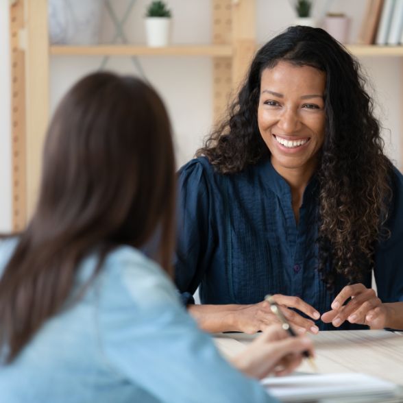 leadership coach smiling with client - Changing Point